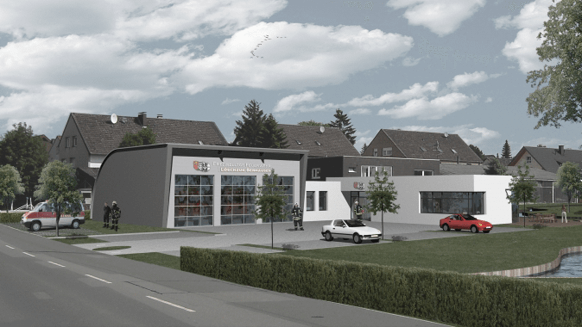 Modernes Feuerwehrhaus mit großen Glasgaragentoren, davor parkende Autos und umgebende Wohnhäuser